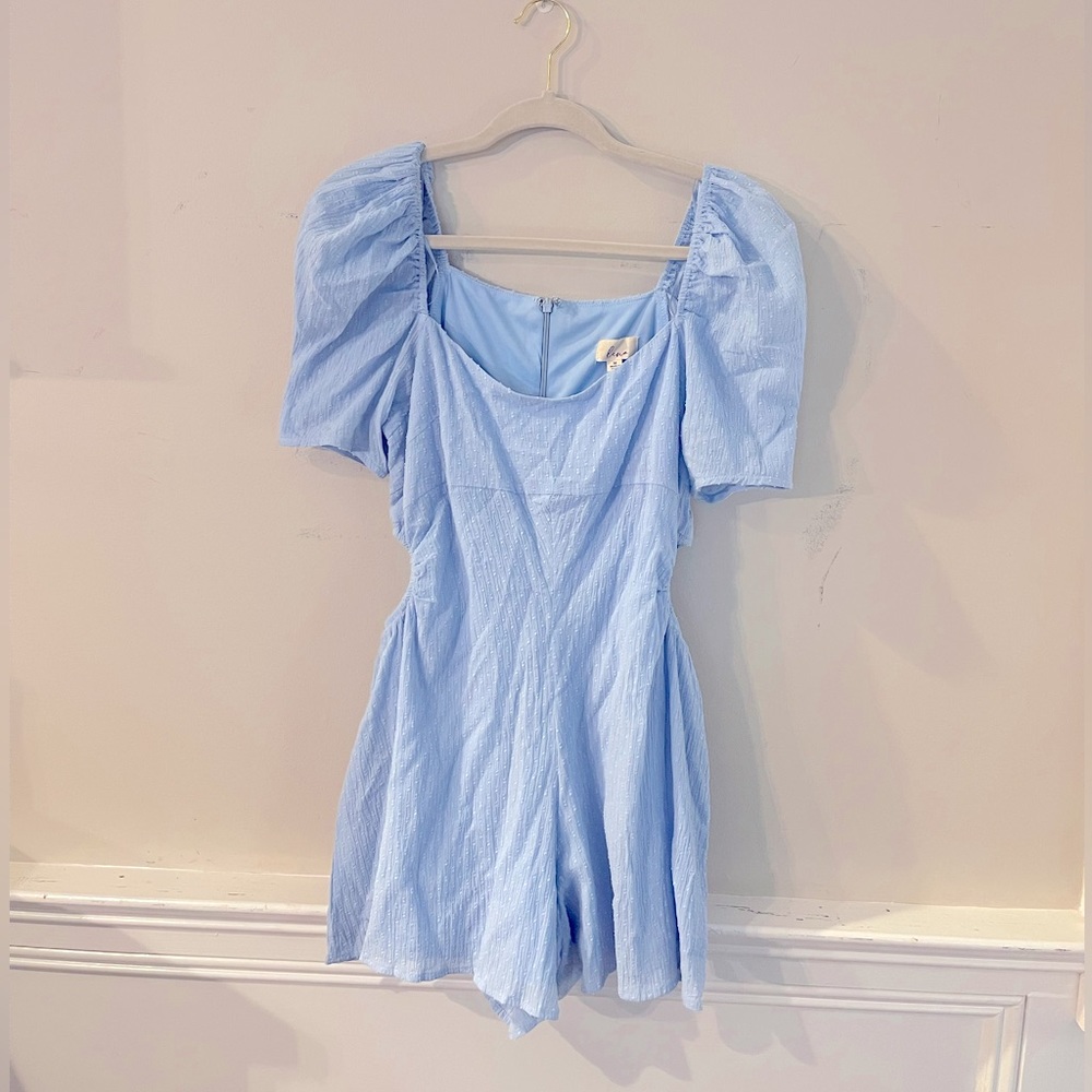 Blue romper with puff sleeves and waist cutouts. Size medium.
